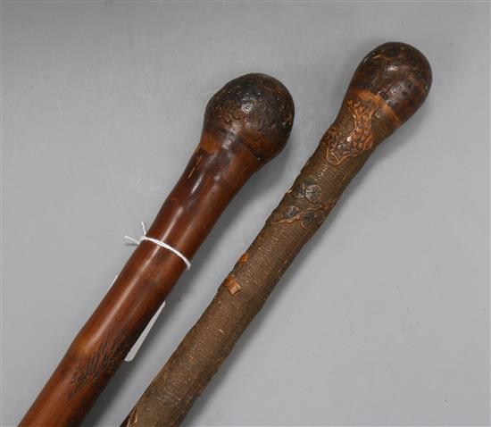 Two late 19th century carved Japanese bamboo walking canes